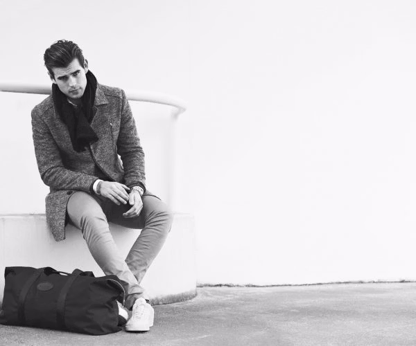 person, sitting, handbag, adult, male, man, coat, shoe, face, head