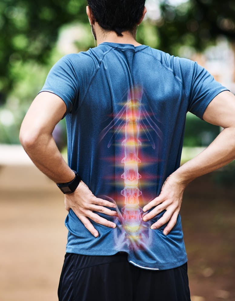 man holding lower back, his spine is lit up