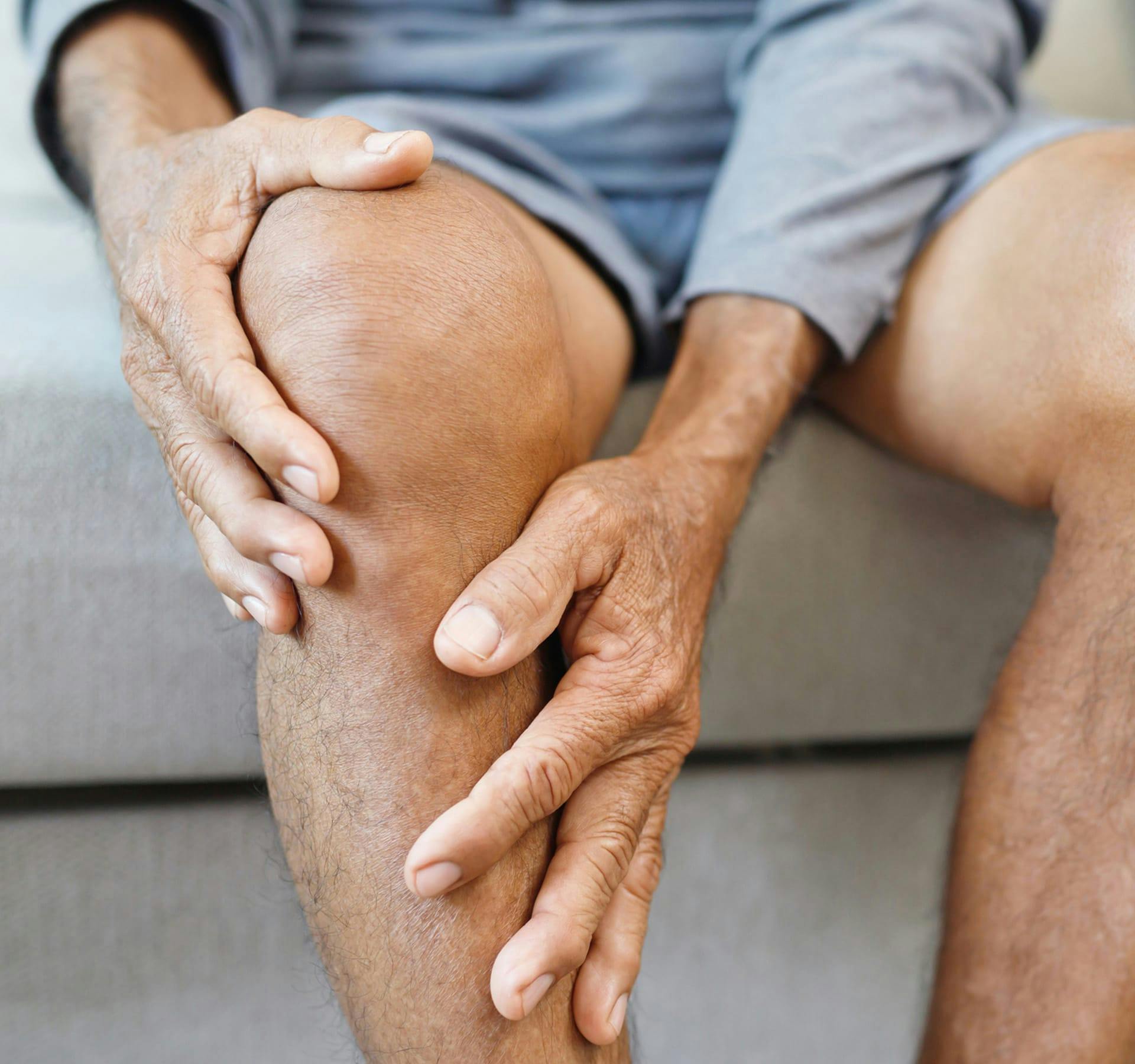 man holding his knee