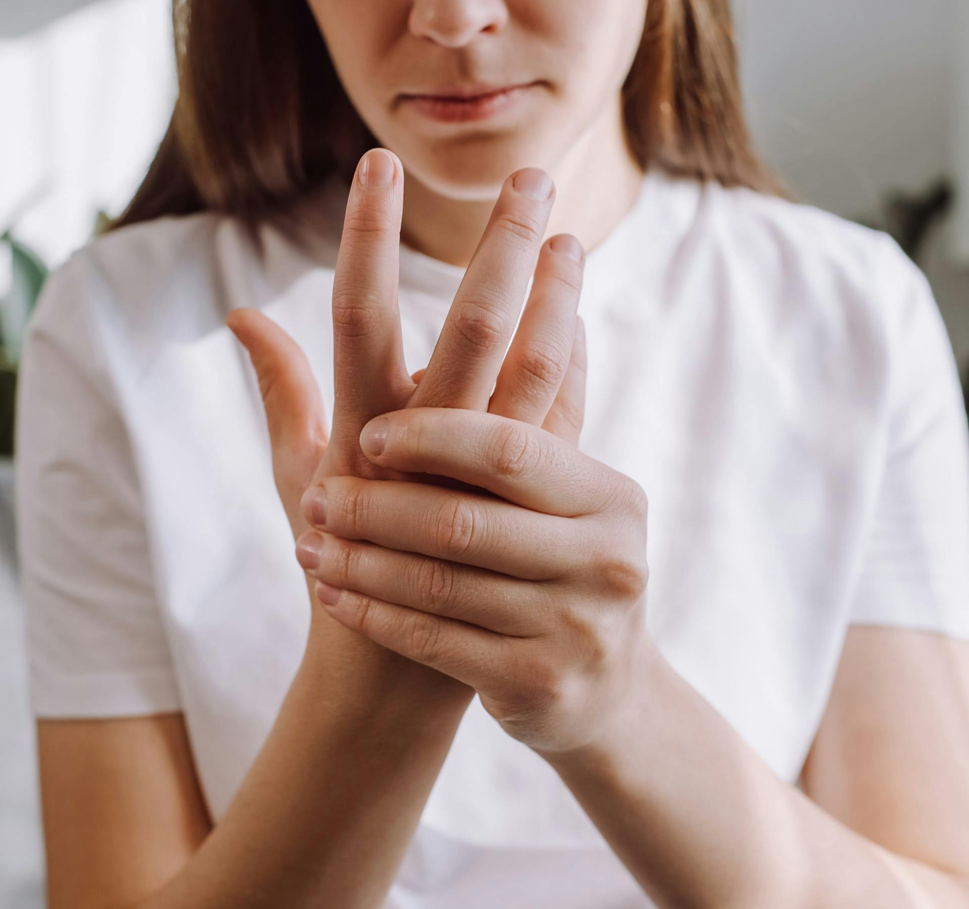 woman holding hand in pain