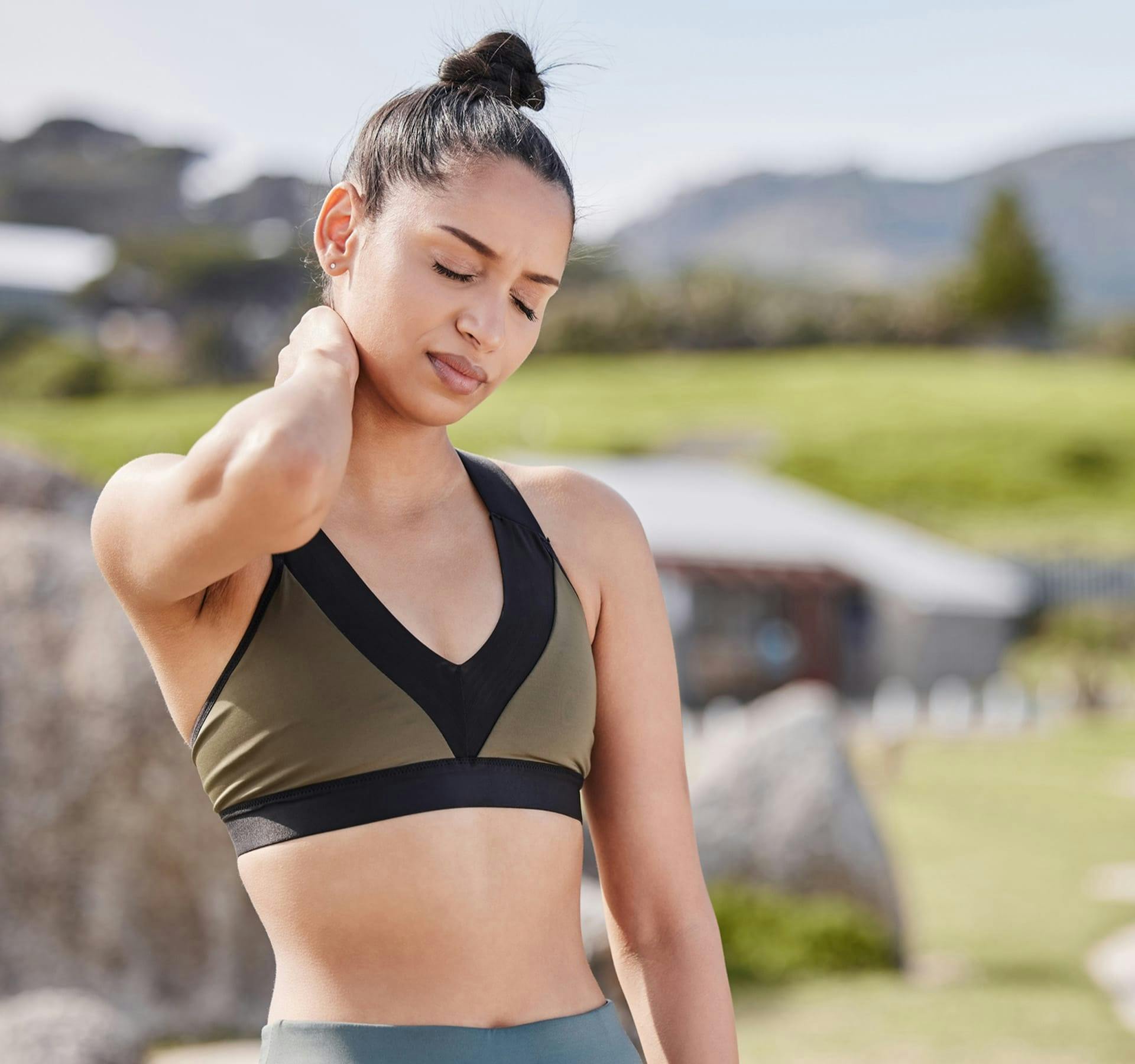 woman holding her neck