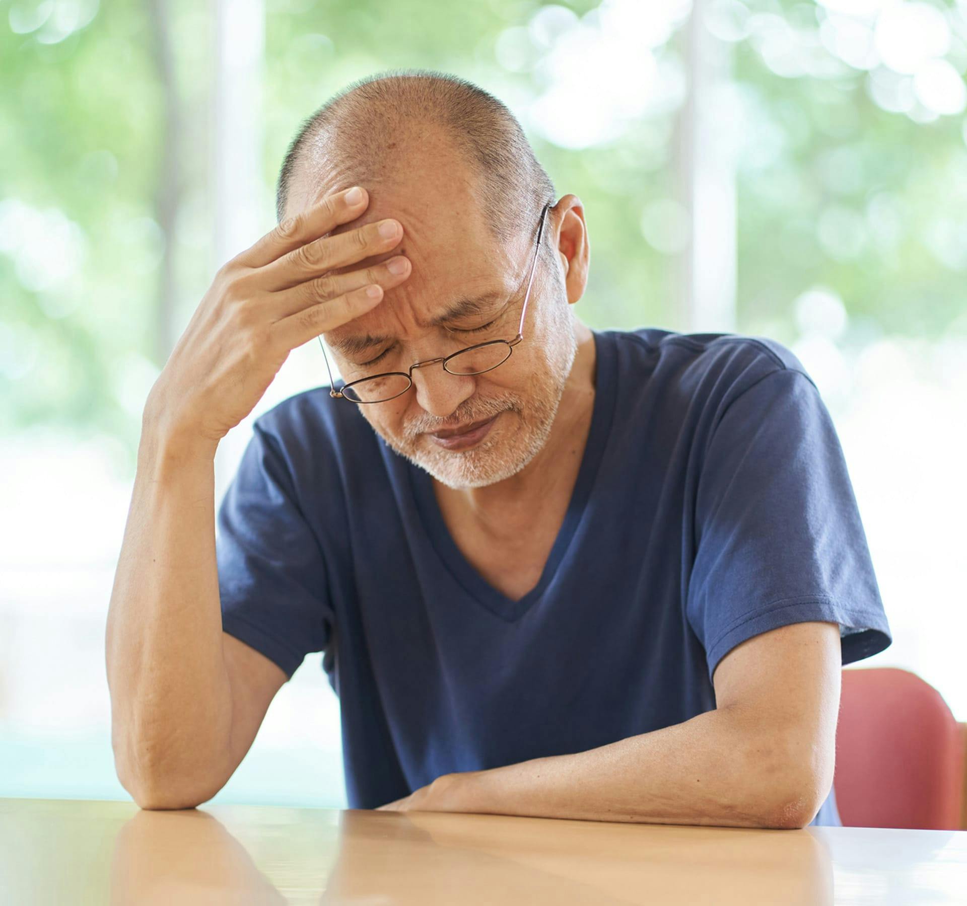 man holding his head in pain
