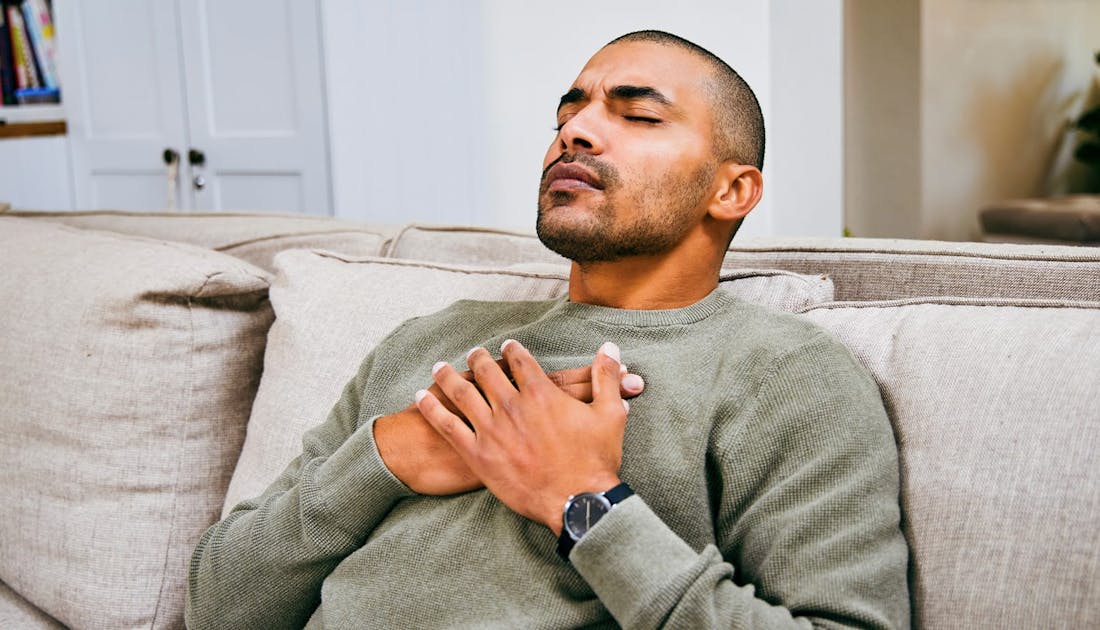 a man holding his chest in pain
