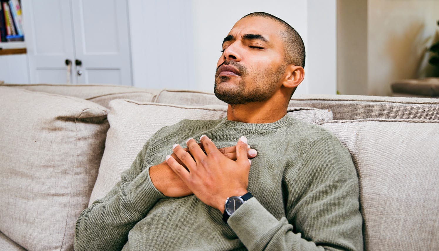 a man holding his chest in pain