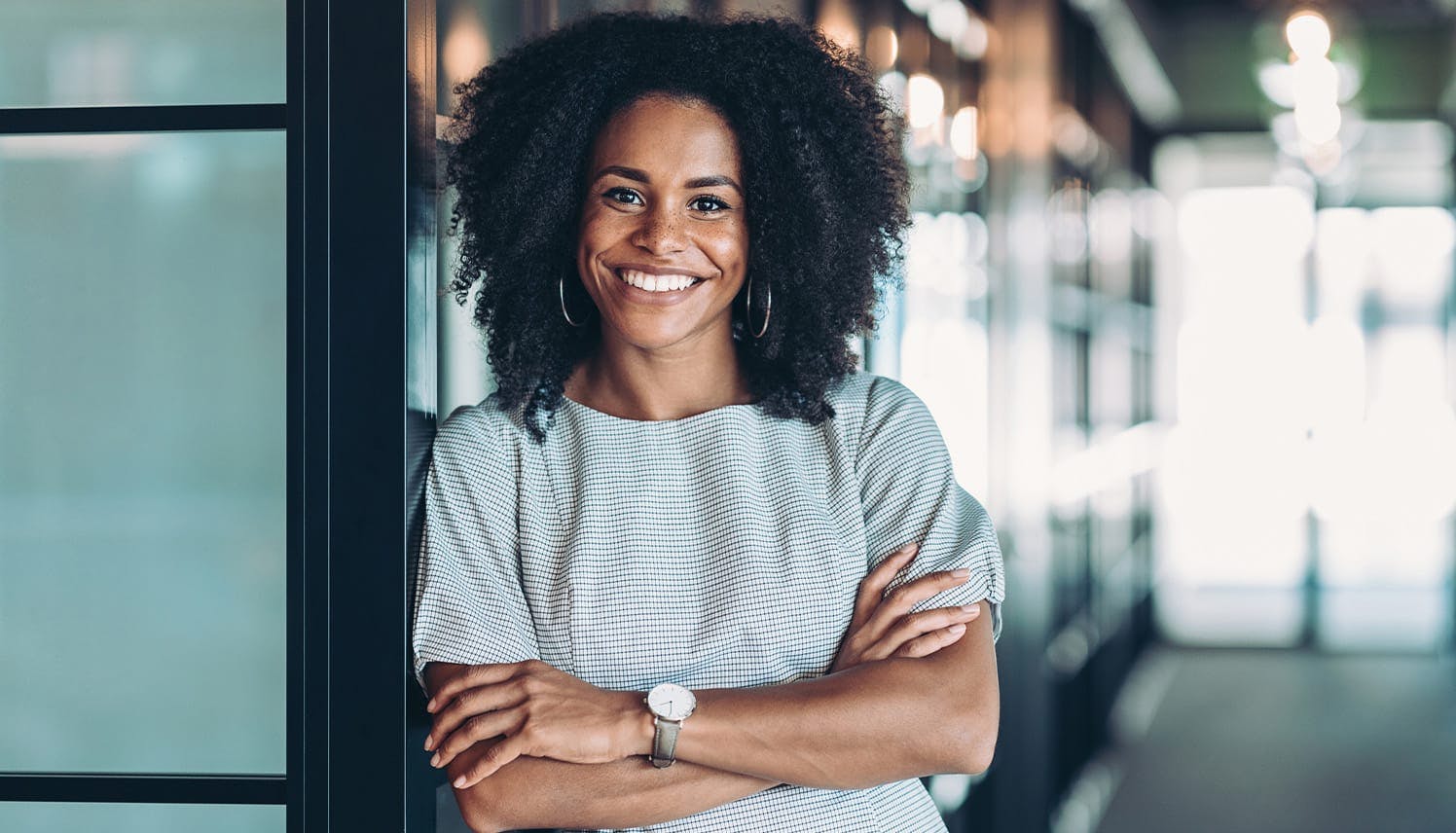 woman smiling, crossing her arms