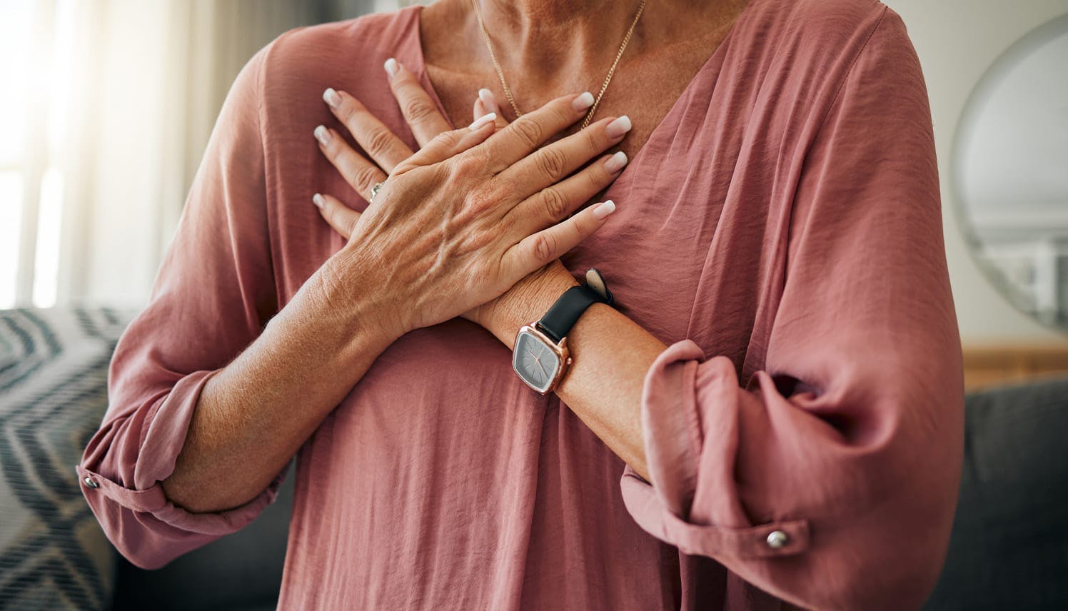 woman holding her hands over her chest