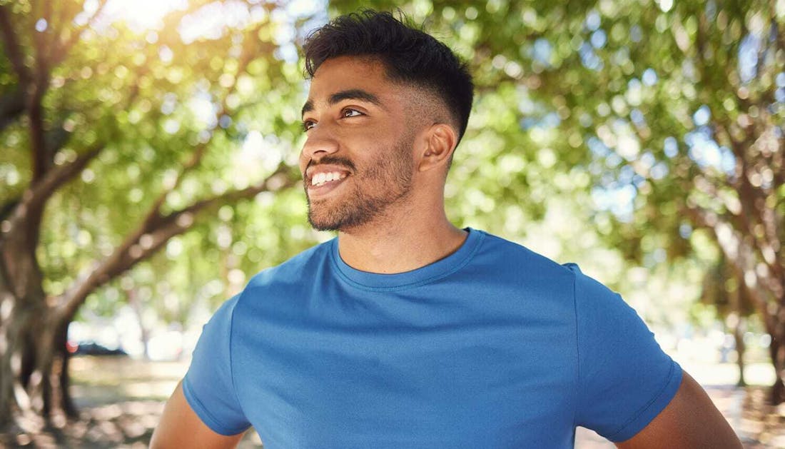 man in a blue shirt outside