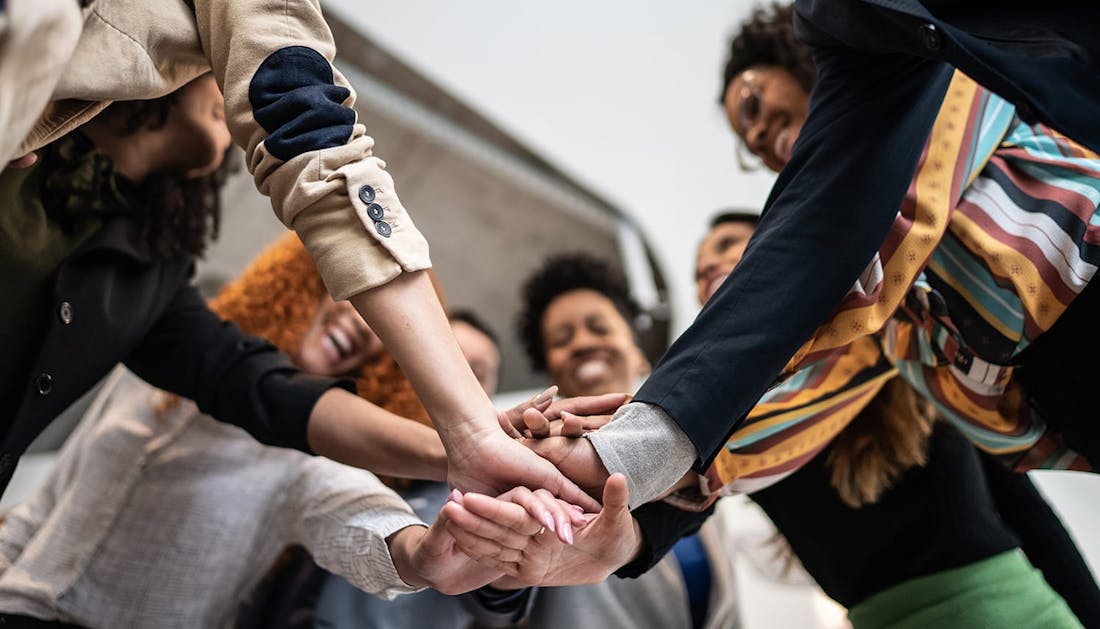 group of people with hands in