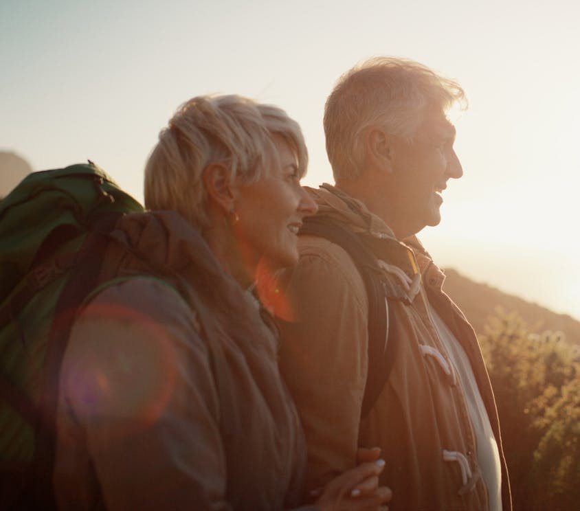A female and male hiker looking out at the view