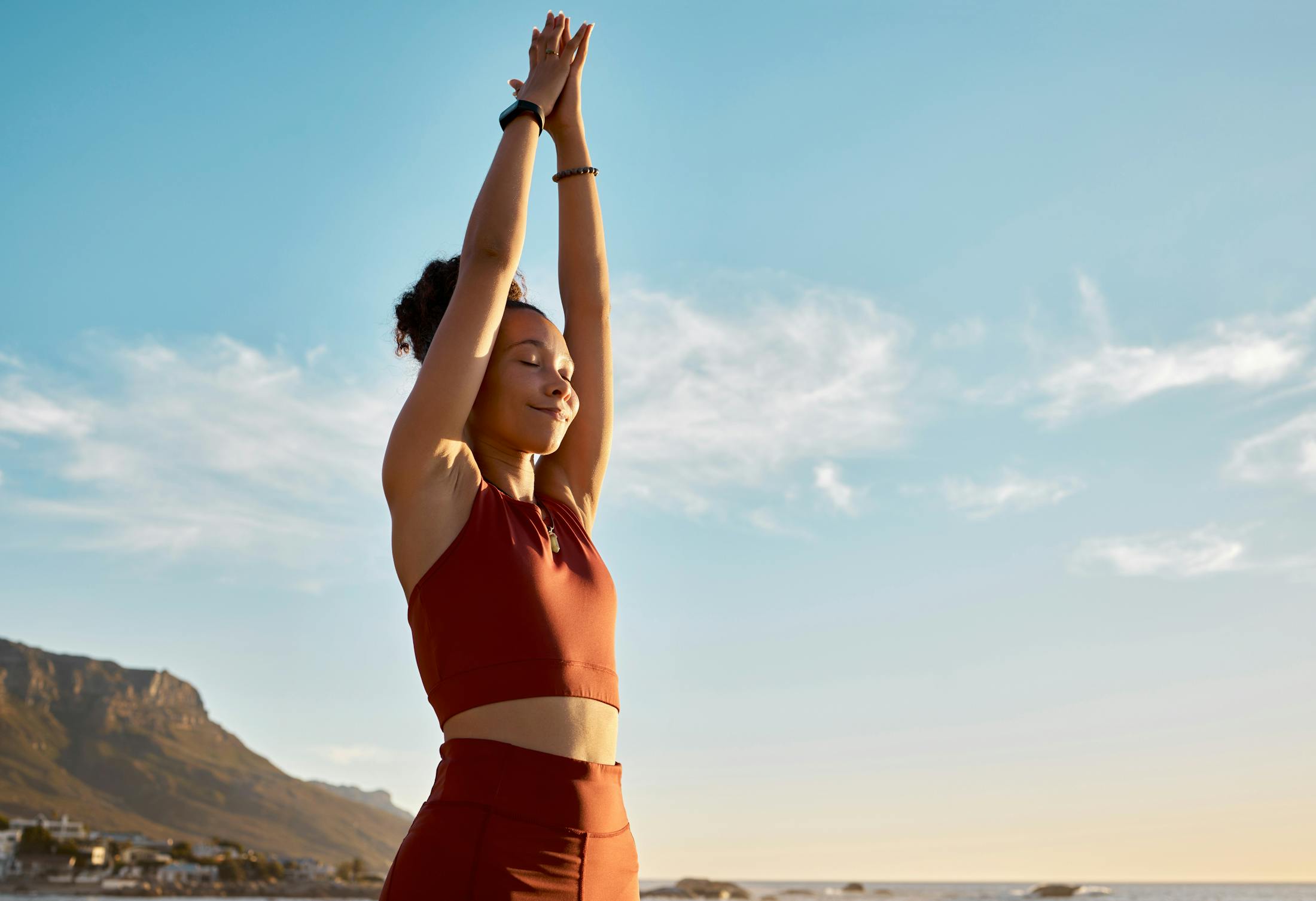 woman exercising outside and smiling