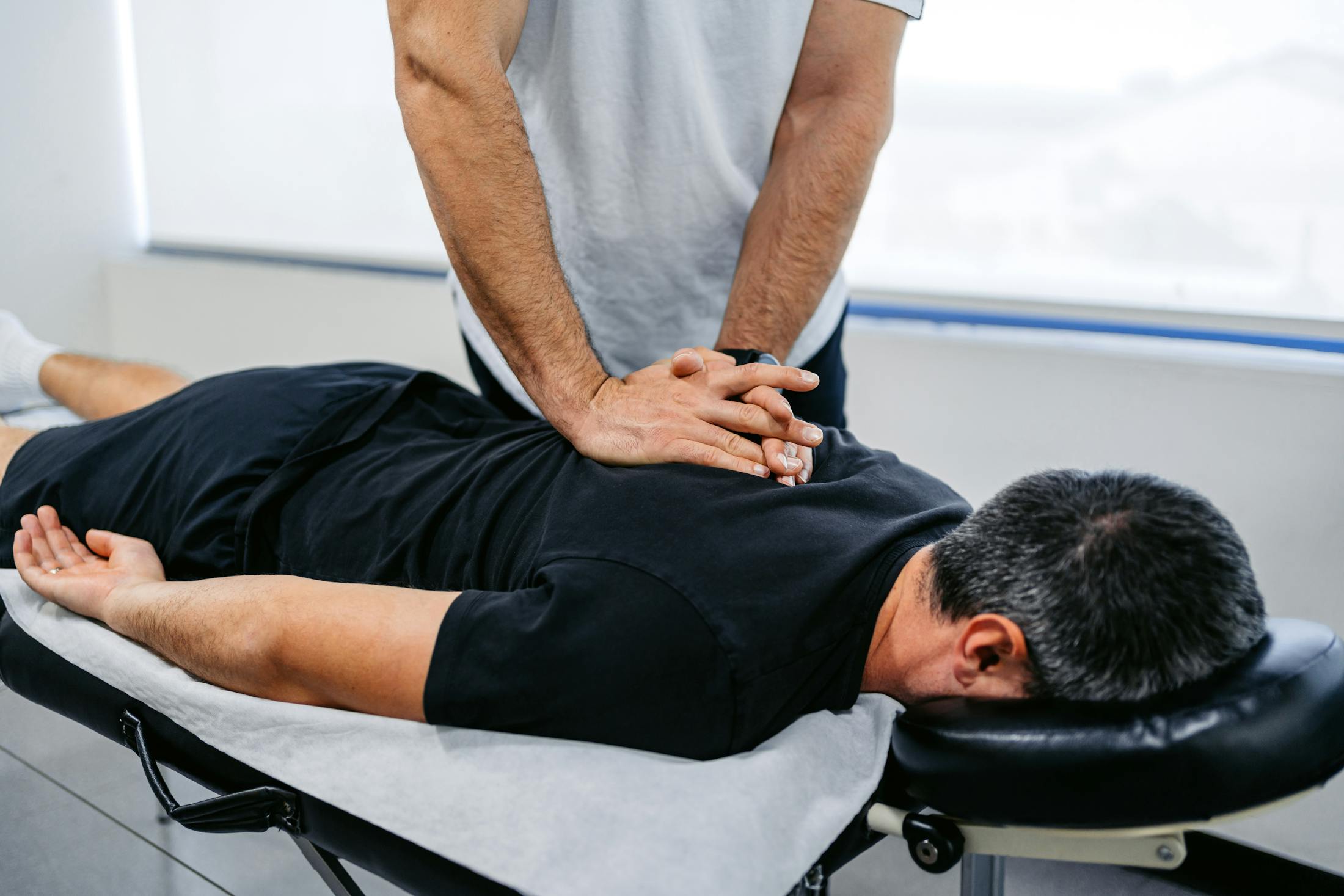Person laying face down on chiropractice table getting a chiropractic adjustment