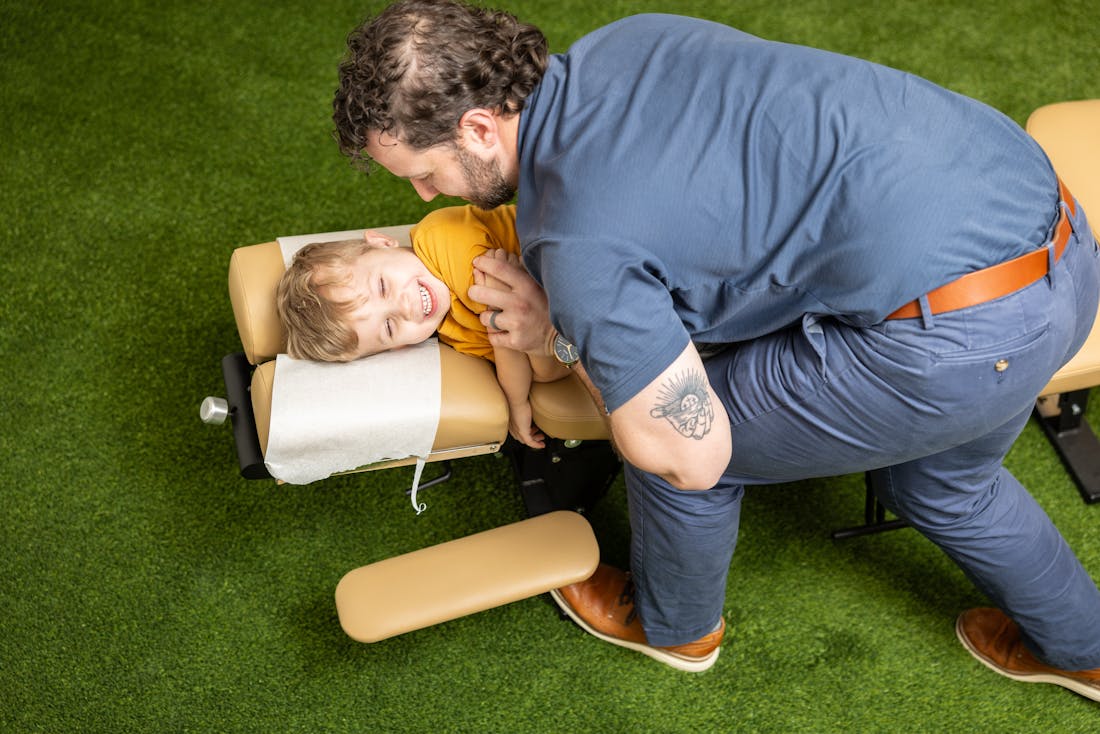 chiropractor adjusting a child