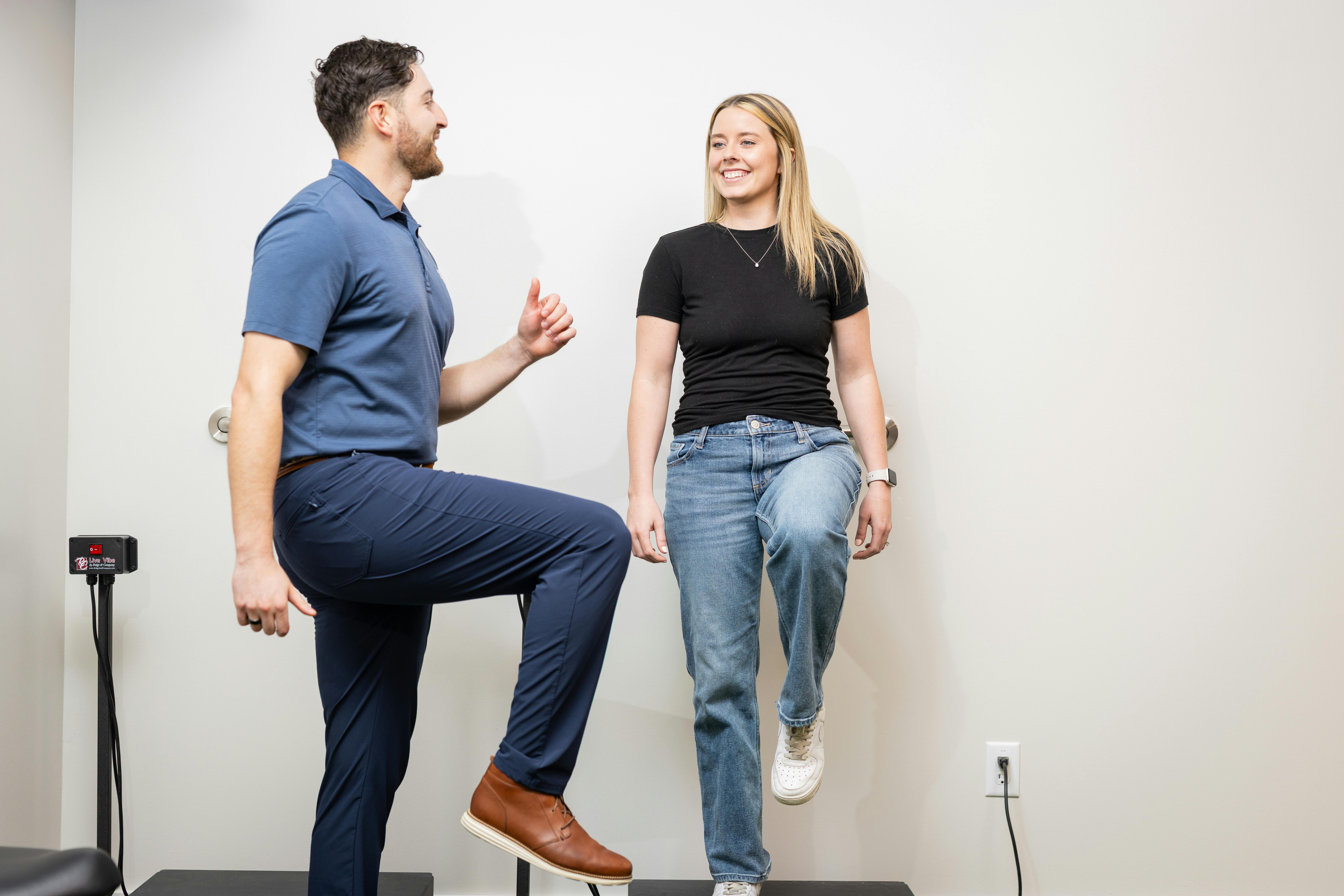 Man doing physical therapy with woman