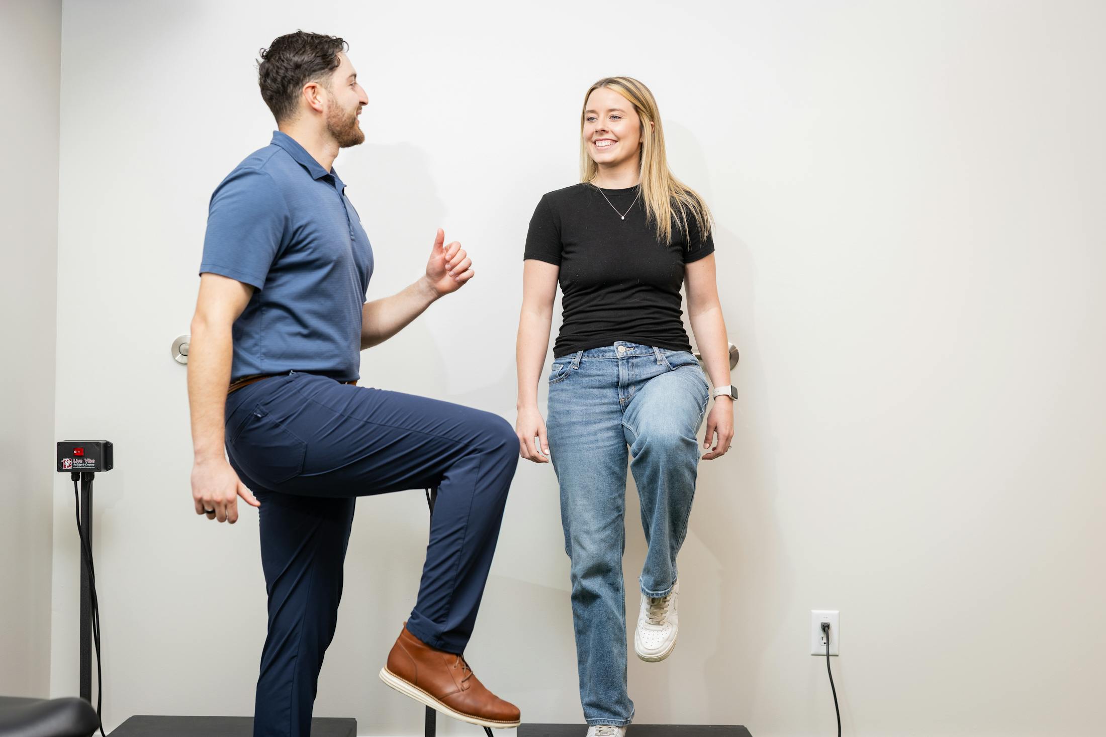 Man doing physical therapy with woman