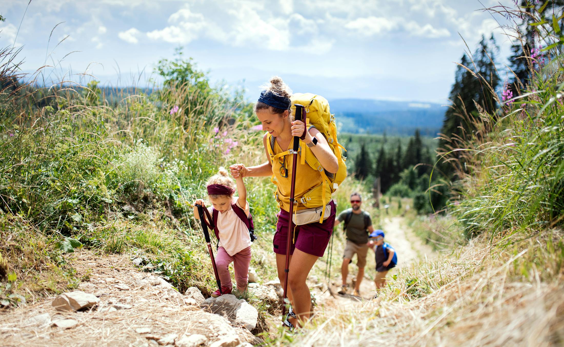 people hiking up a mountain looking happy