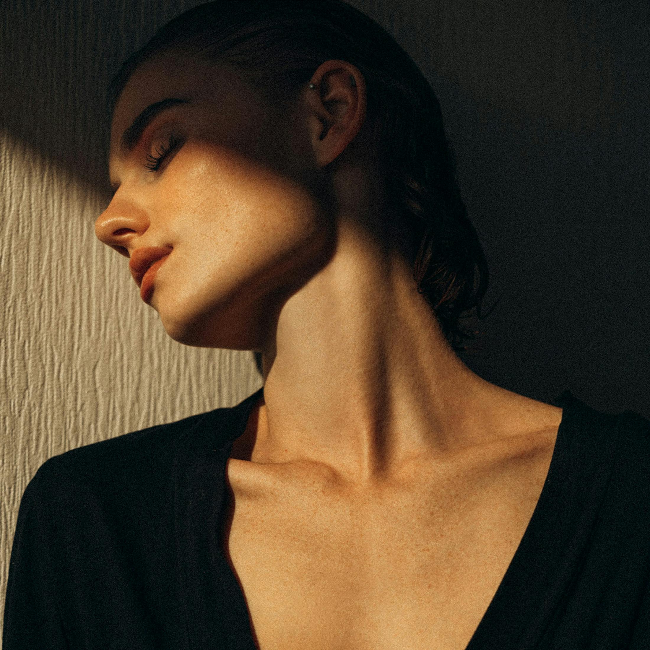 woman half hidden in shadows