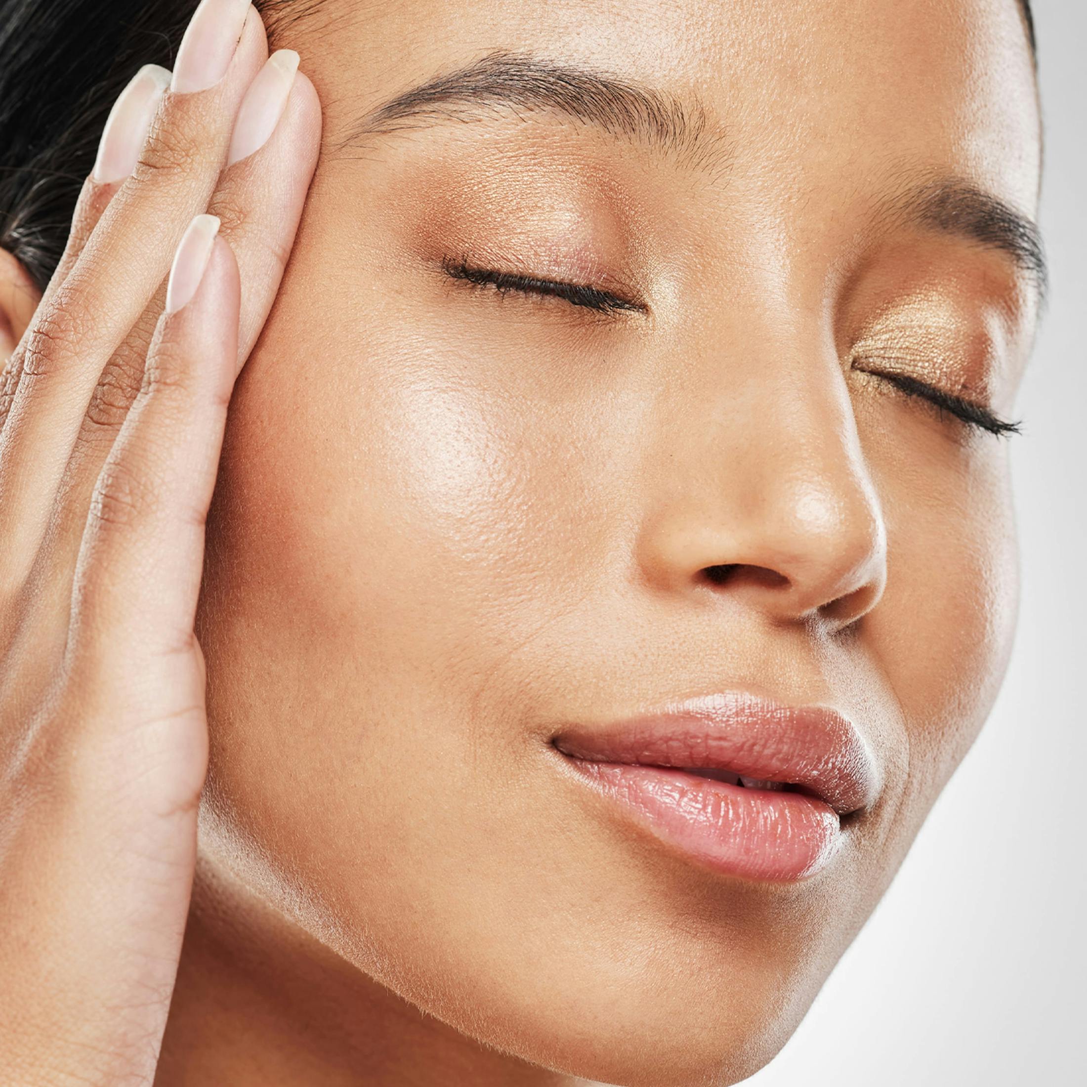 woman touching her face
