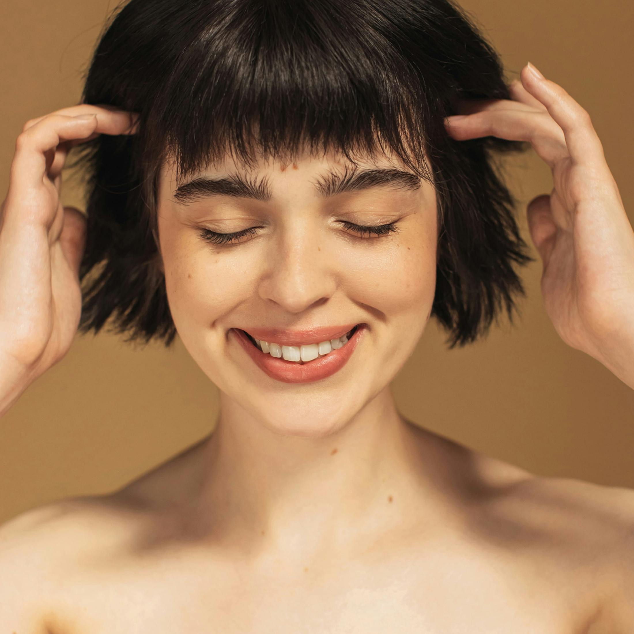 woman pushing her hair behind her ears