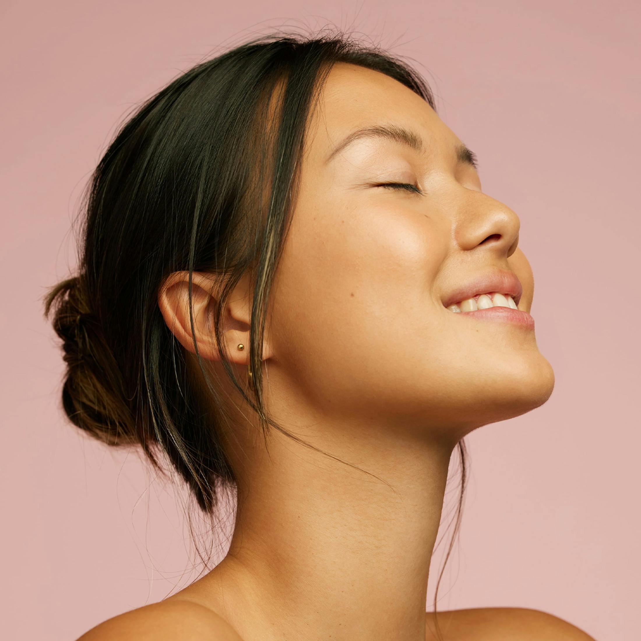 woman smiling with her eyes closed