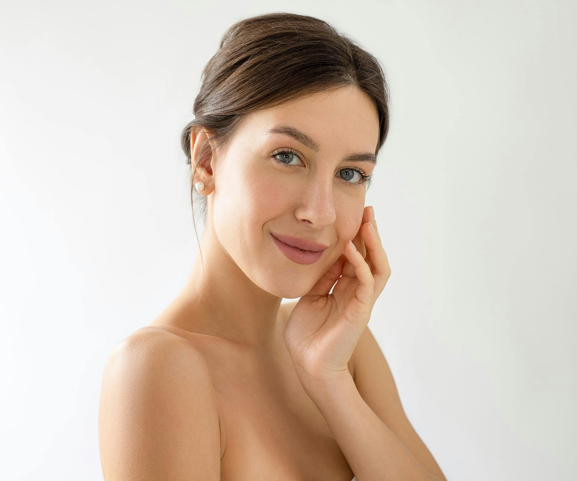 woman touching the side of her face