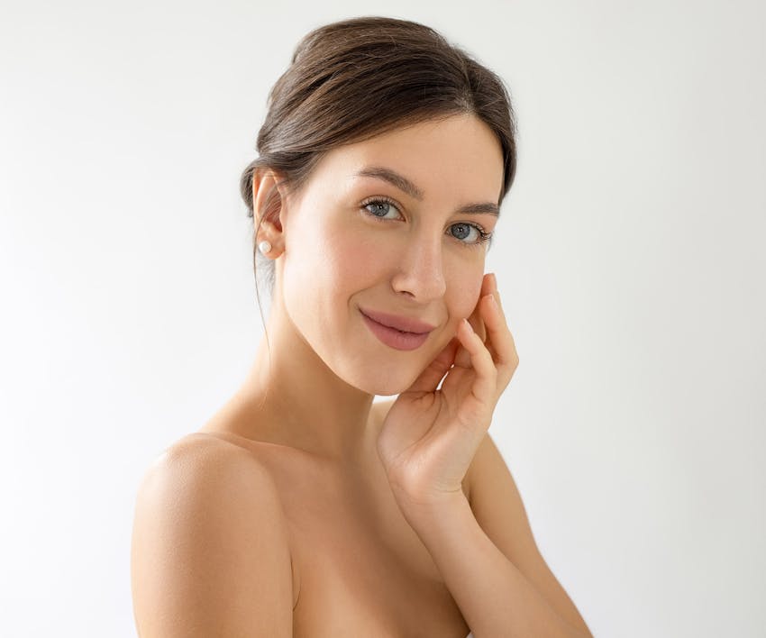 woman touching the side of her face