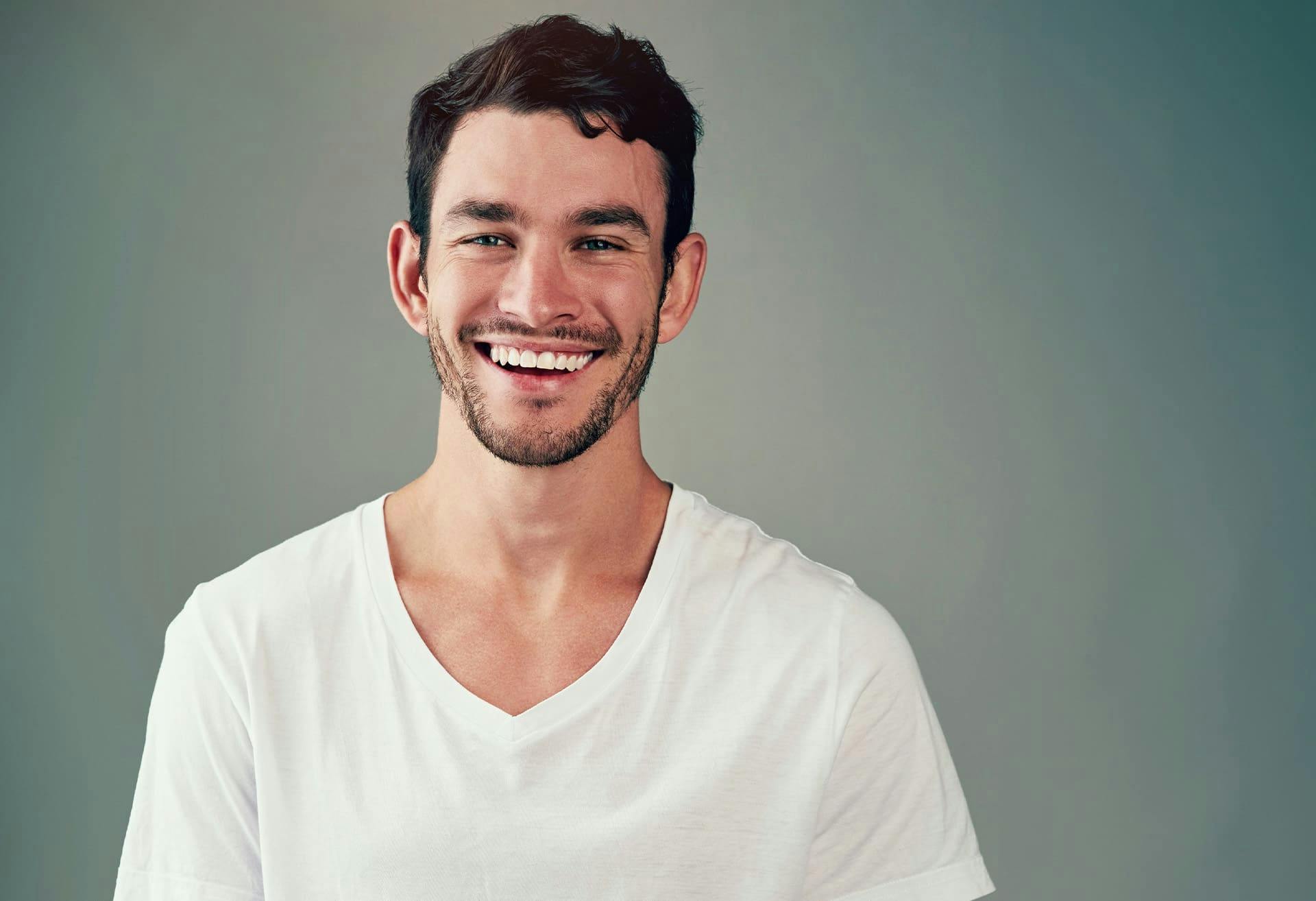 man smiling in white t-shirt