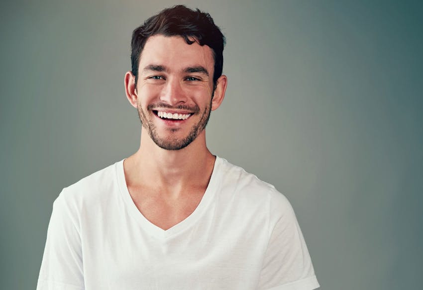 man smiling in white t-shirt