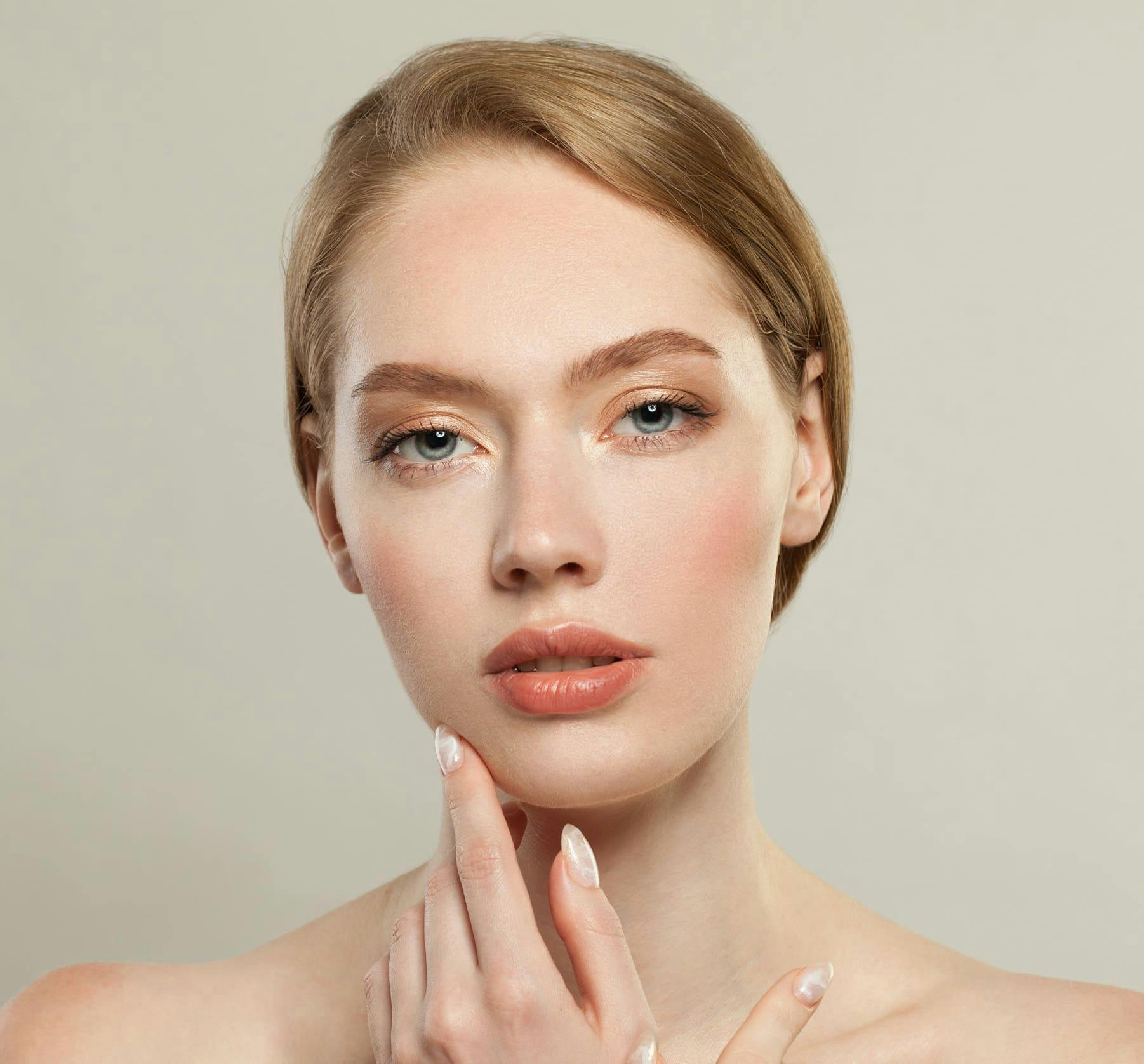 Close up of woman touching chin