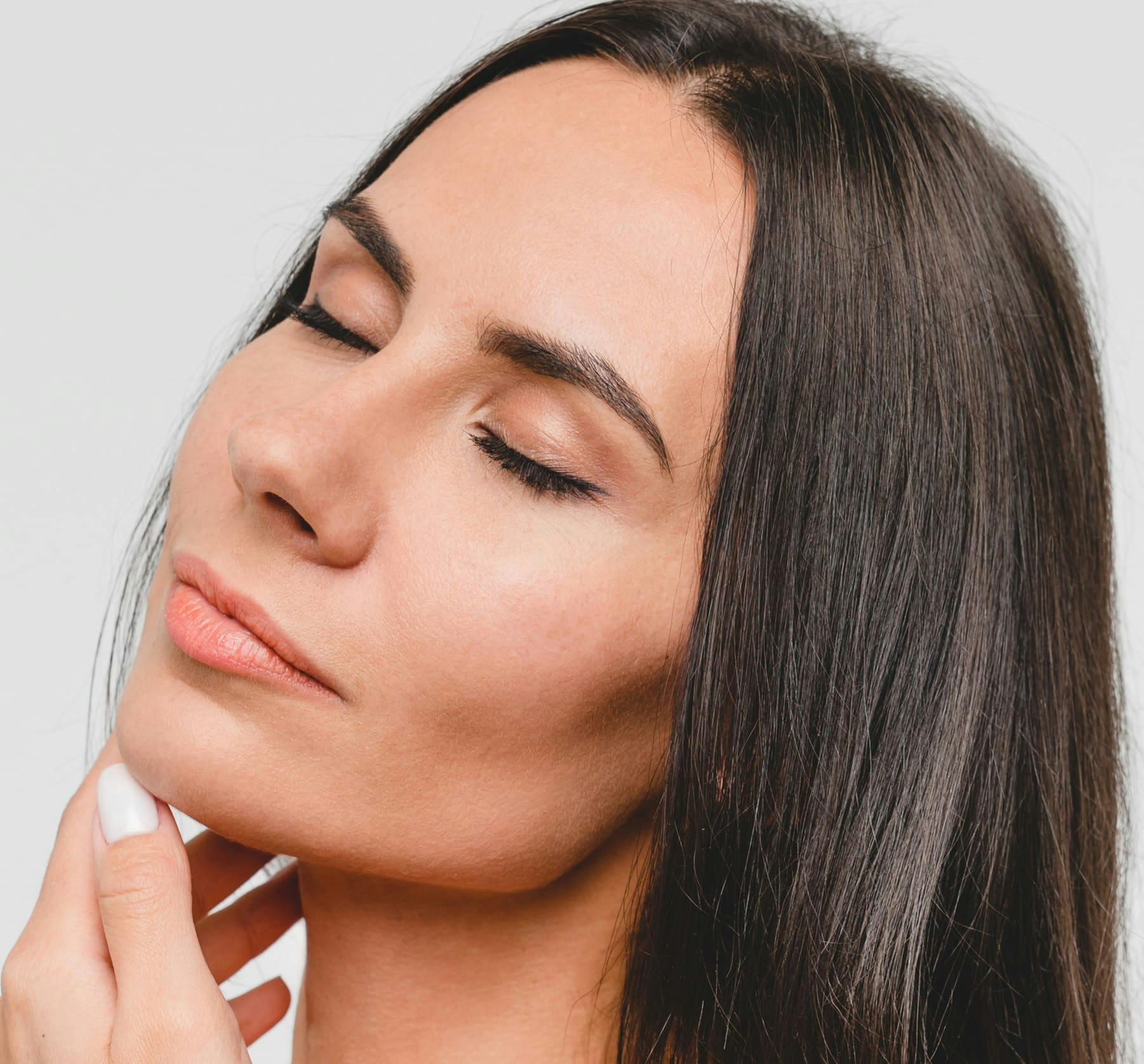 Close up of woman touching chin