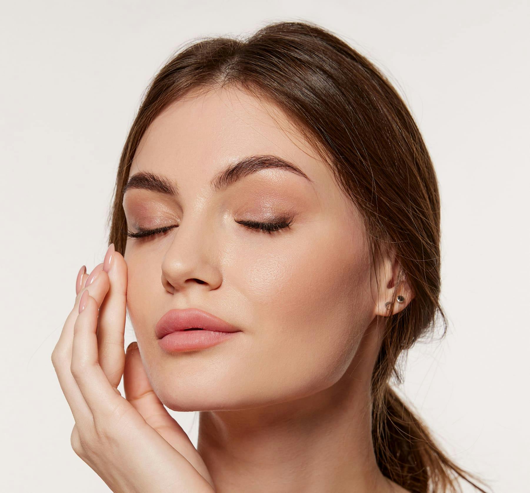 Close up of a woman touching her cheek