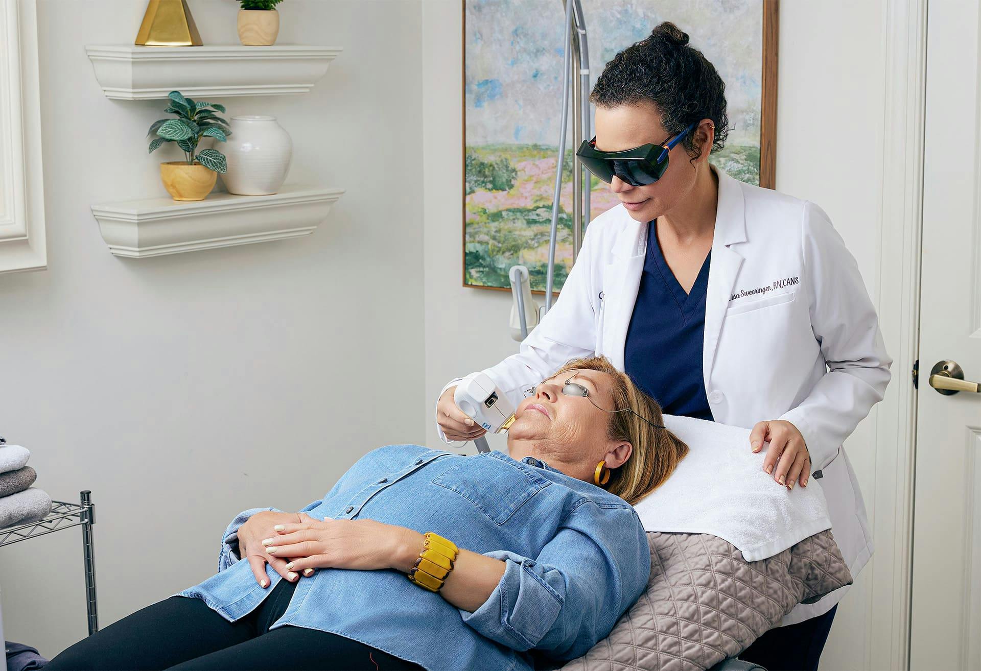 patient getting a laser treatment by staff member