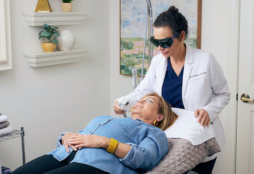 patient getting a laser treatment by staff member