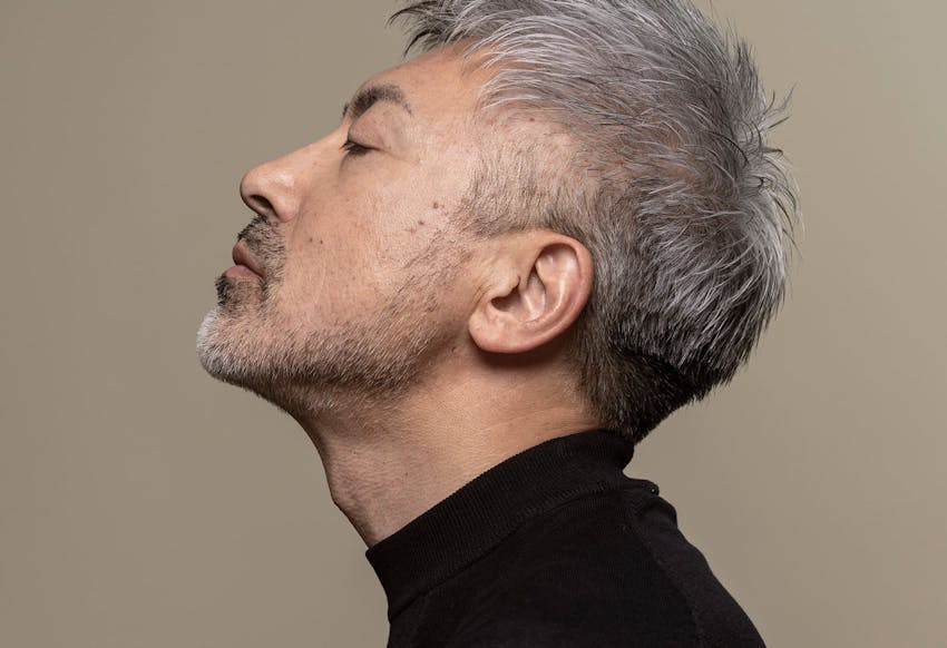man tilting his head upwards while facing to the side
