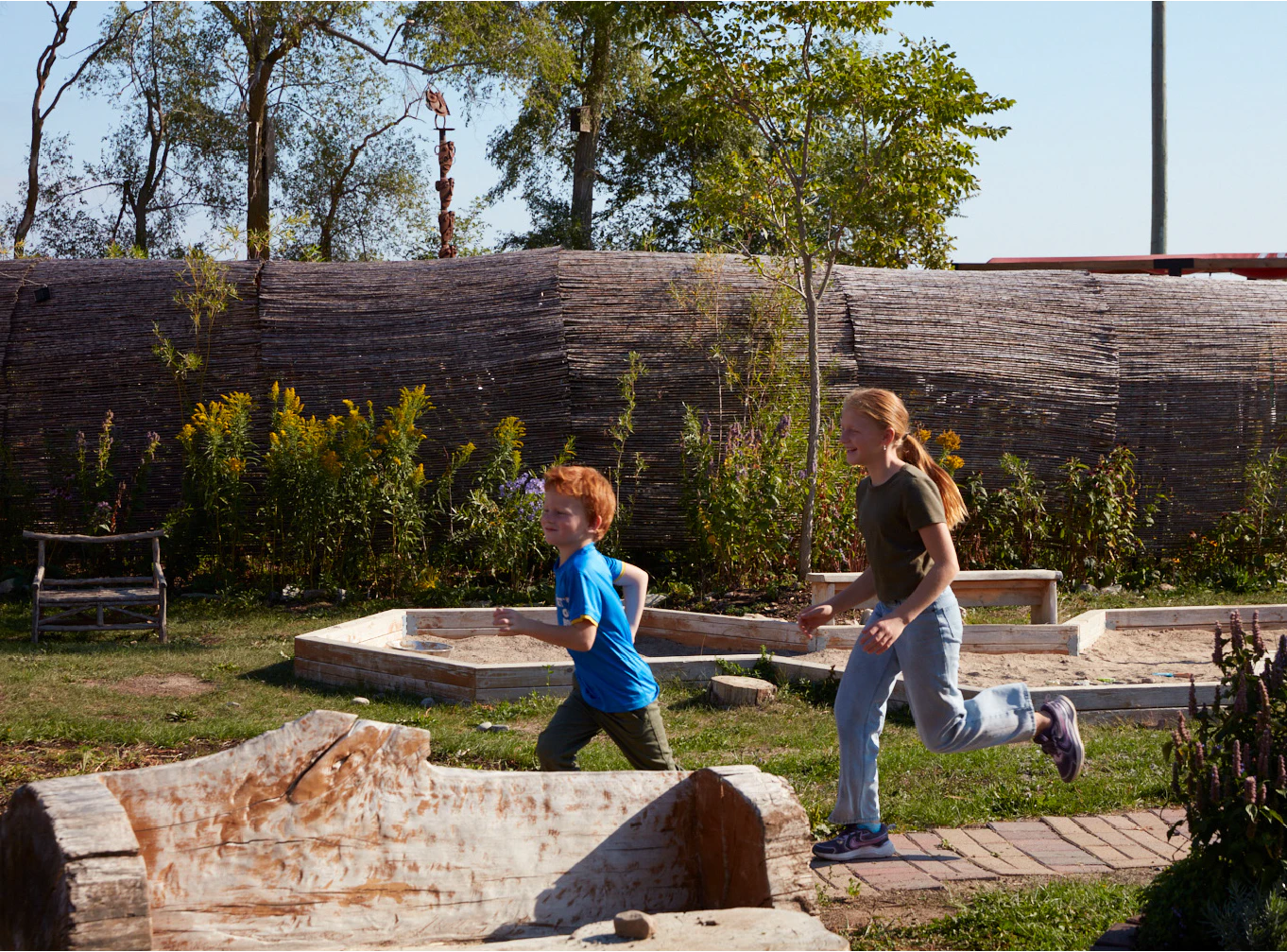 Two children running through the sensory garden of Base 31