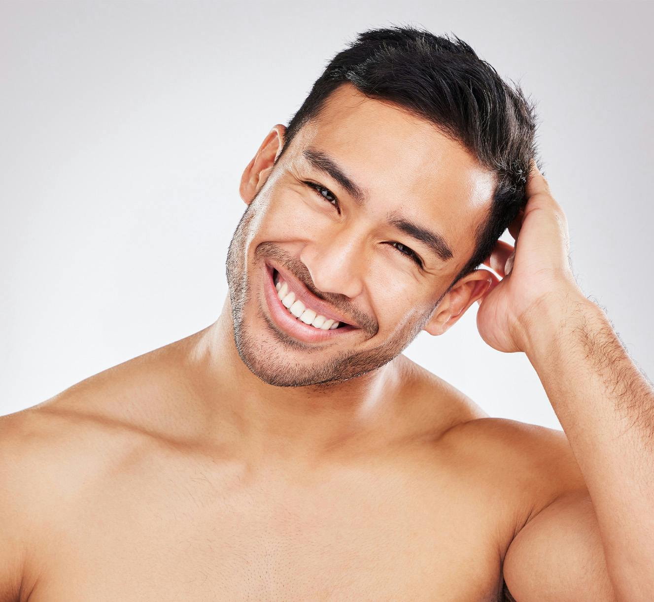 mann with head in hands smiling