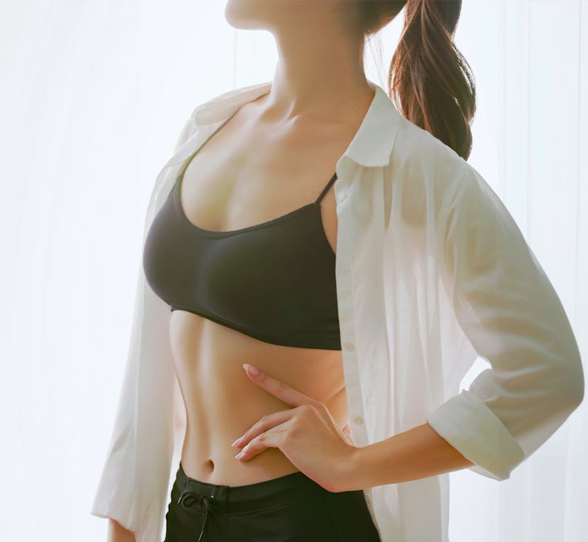 womans body with hand on hip