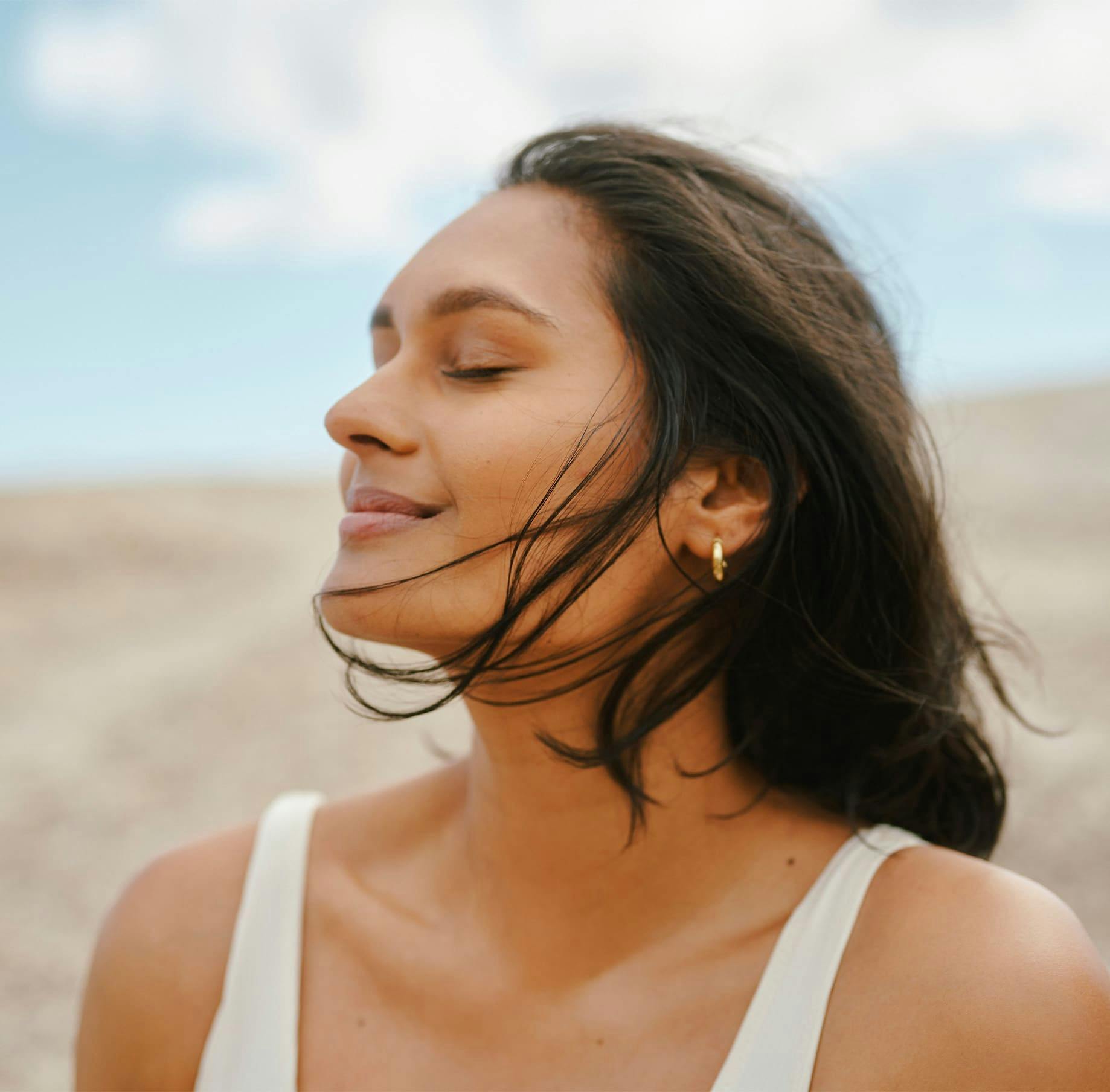 Woman with eyes closed smiling