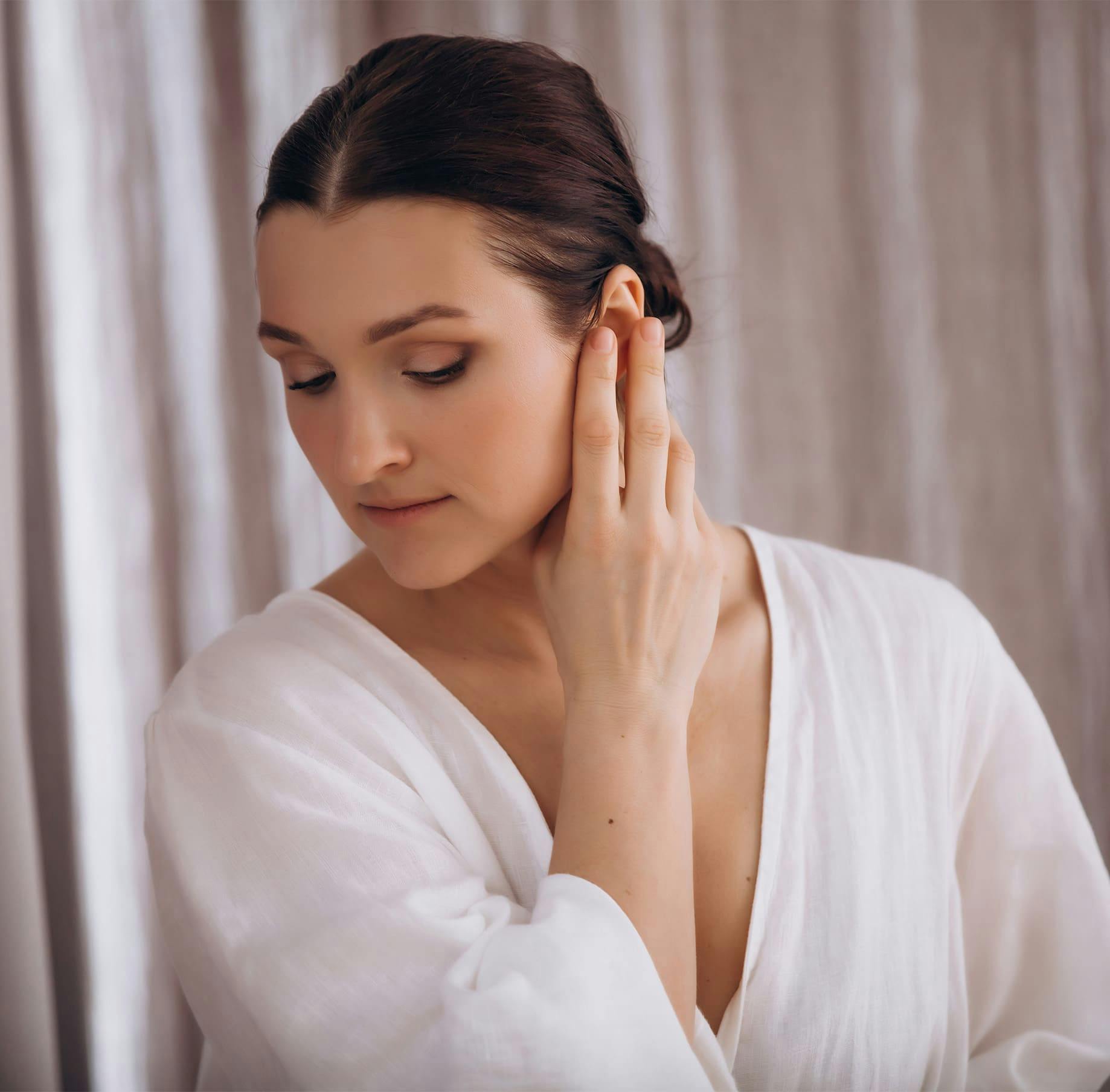 Woman touching her ear