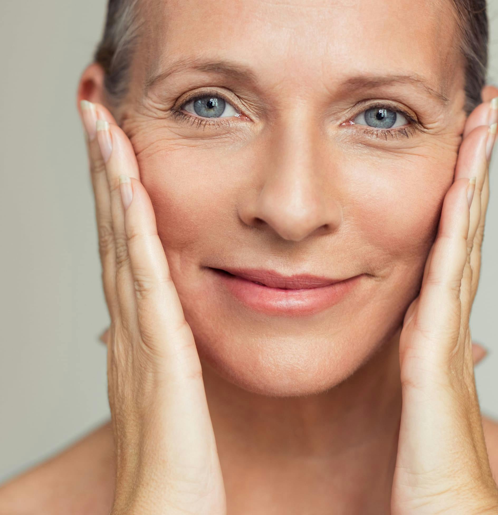 Woman smiling touching cheeks