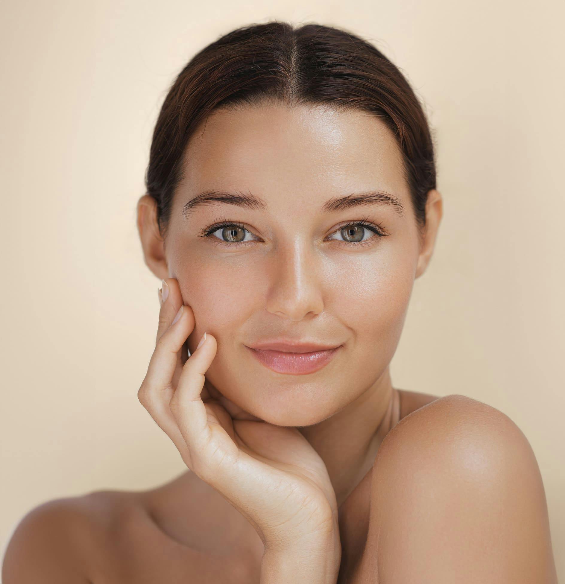 Woman smiling and resting chin on hand
