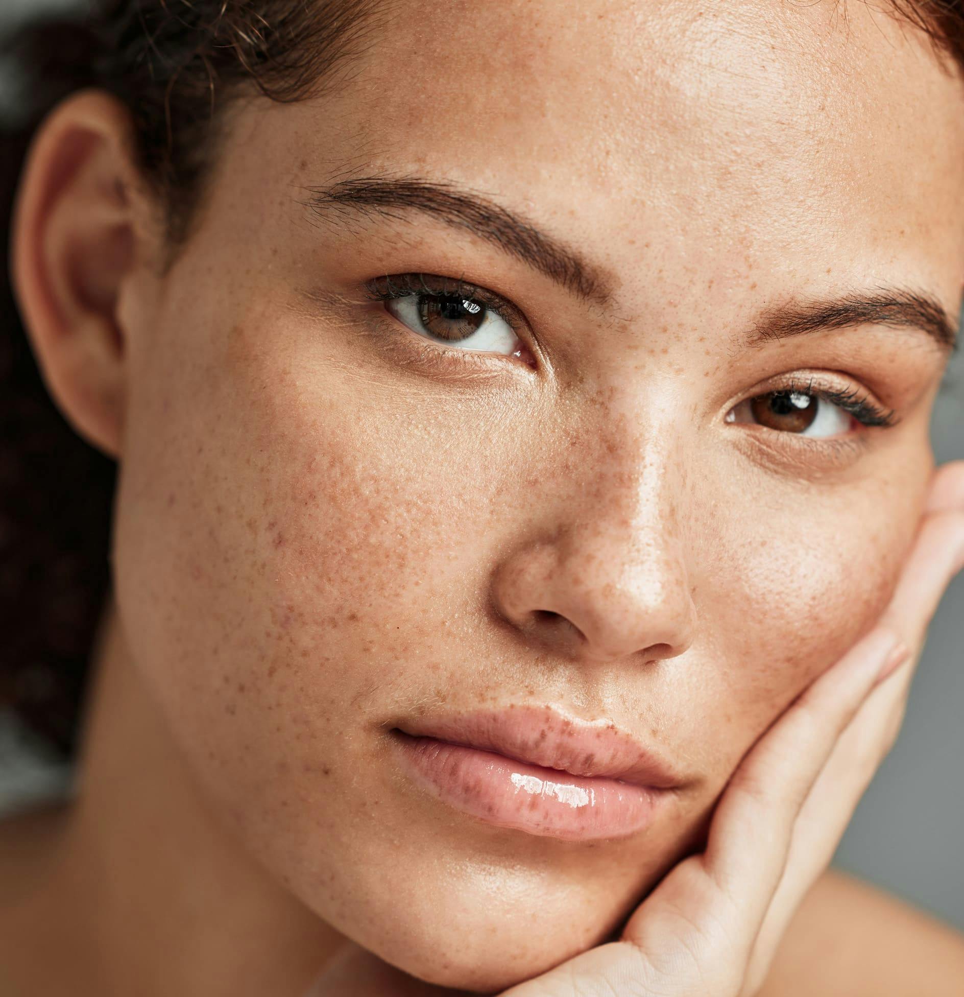 Close up of a woman touching her face