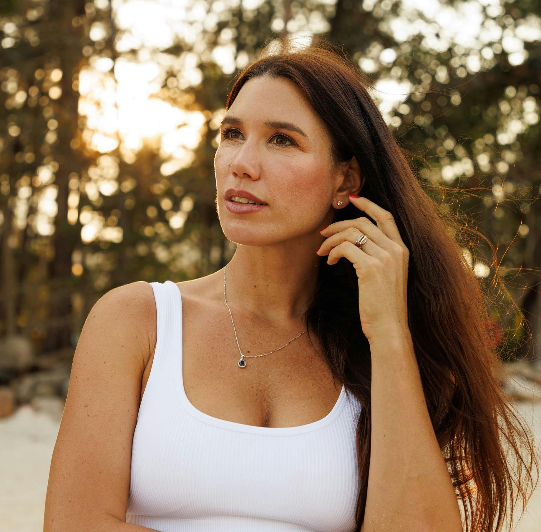 Woman brushing hair back