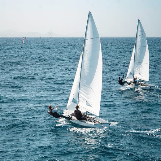 2 sail boats out in the ocean