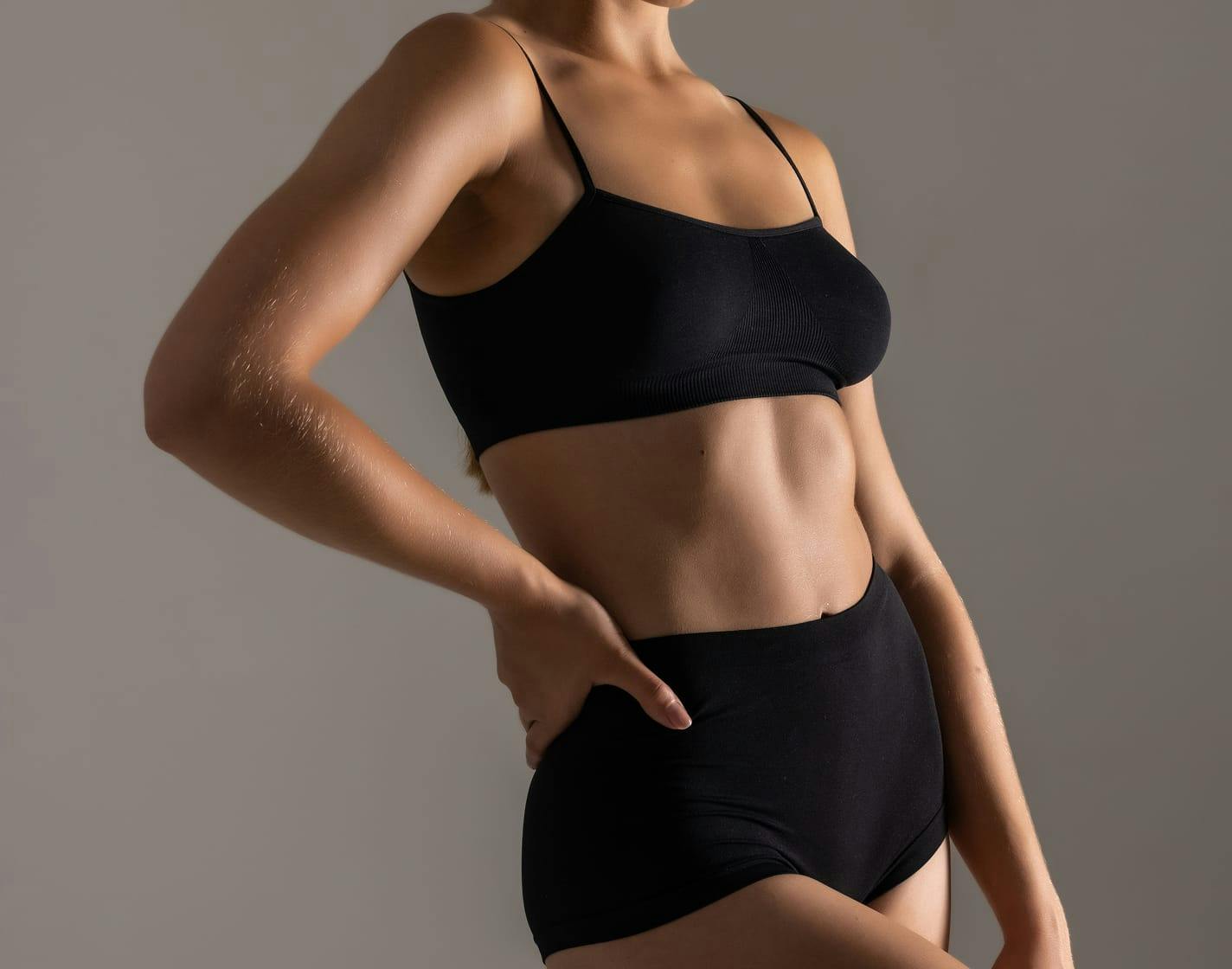 woman with hand on hip in black underwear
