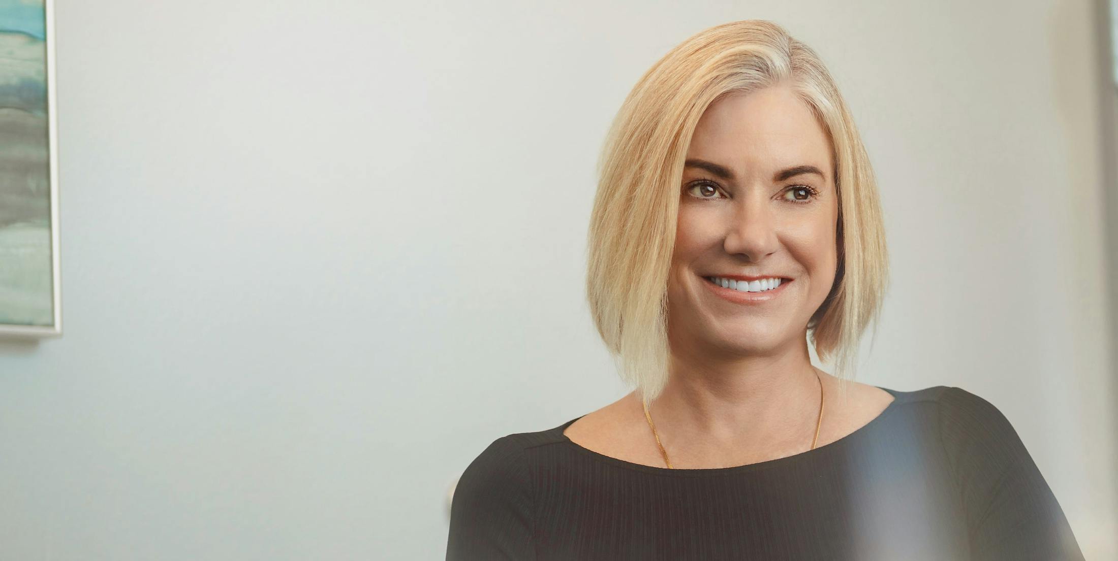 Patient, Kimberly, smiling looking forward in a black top