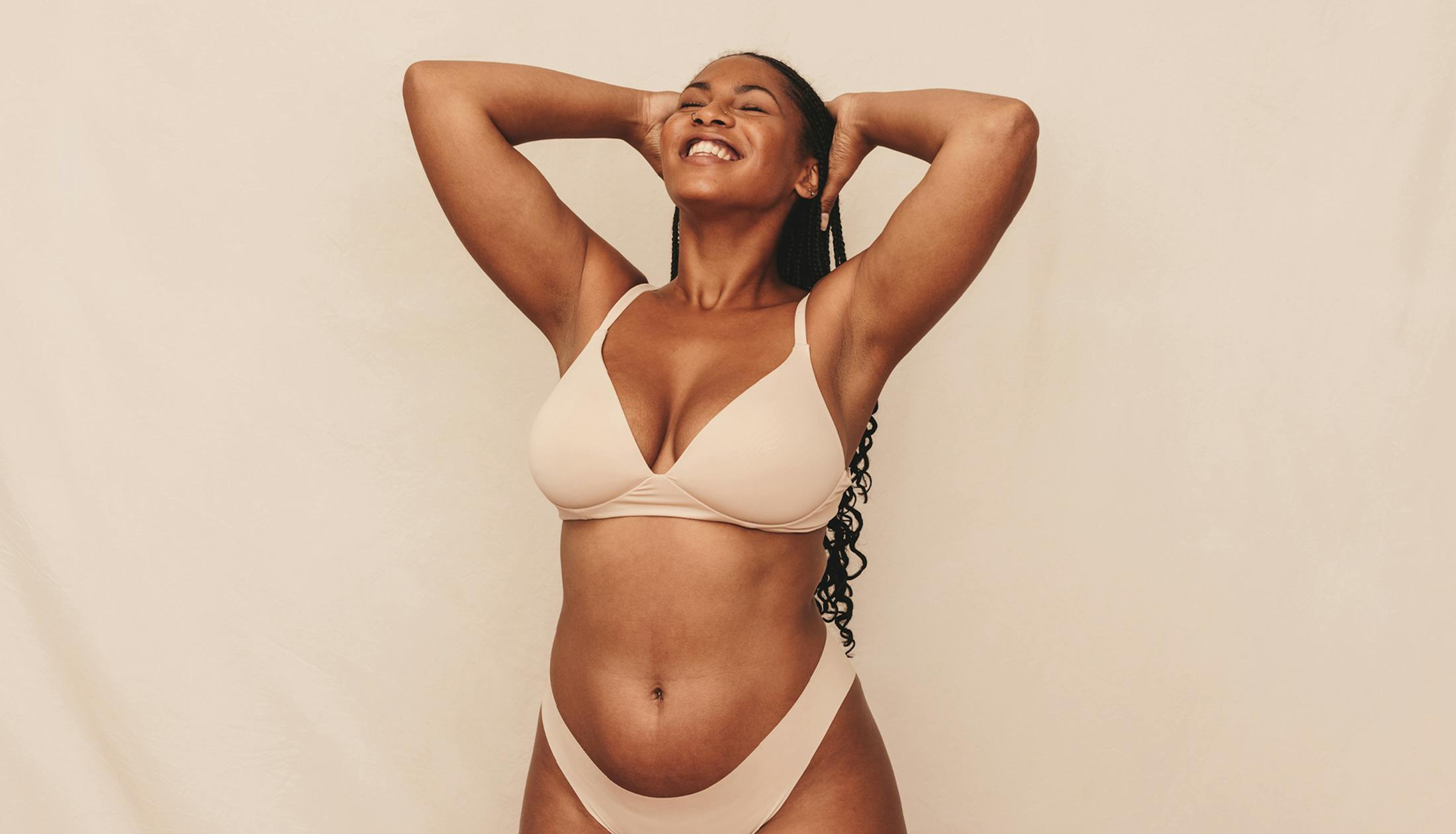 woman with her arms on her head looking up