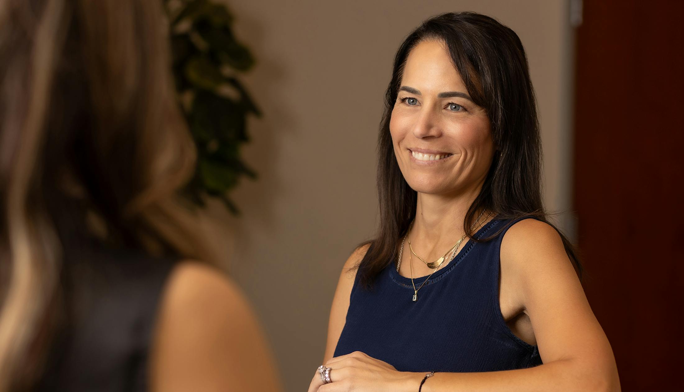 woman smiling at another woman