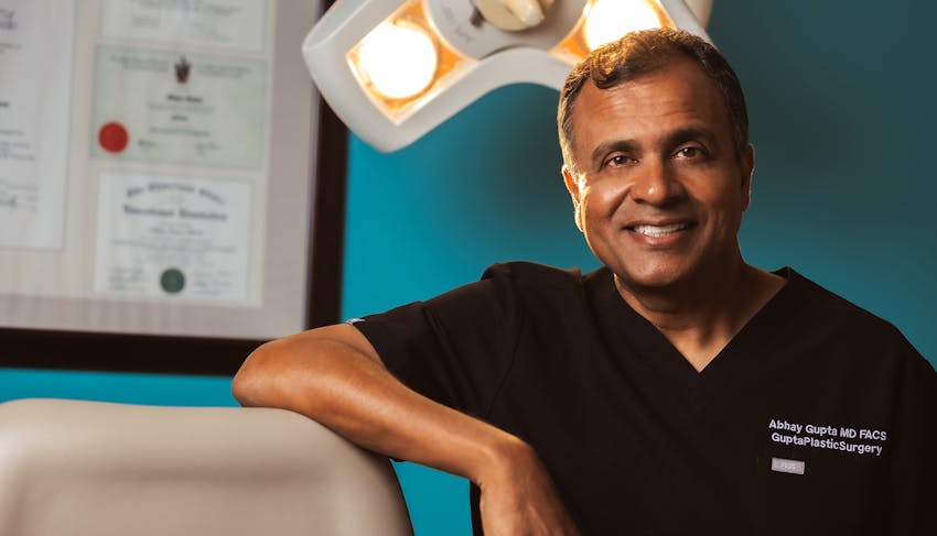 Dr. Abhay Gupta leaning his elbow on the counter