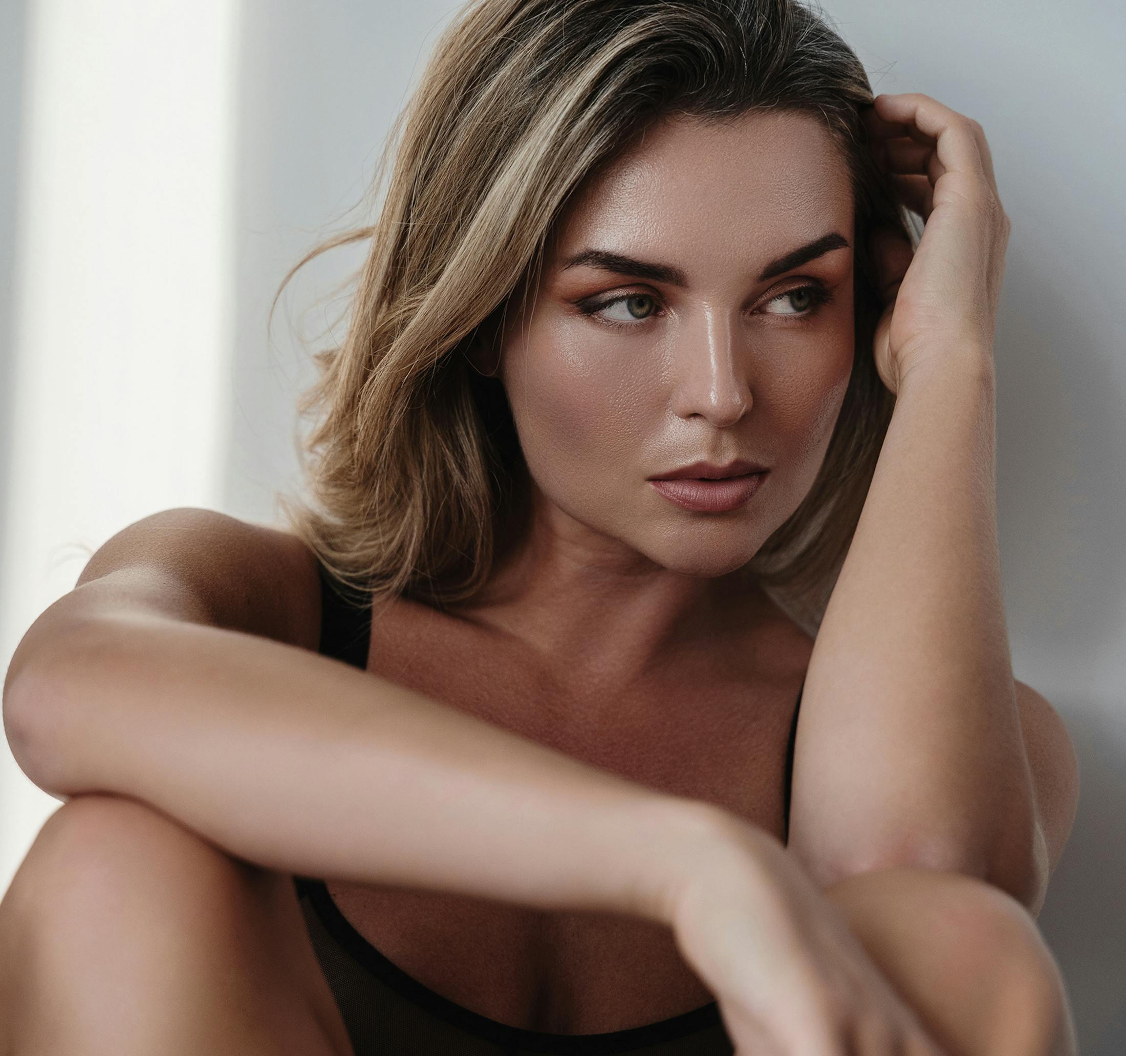 woman with her knees raised and her elbow resting on one