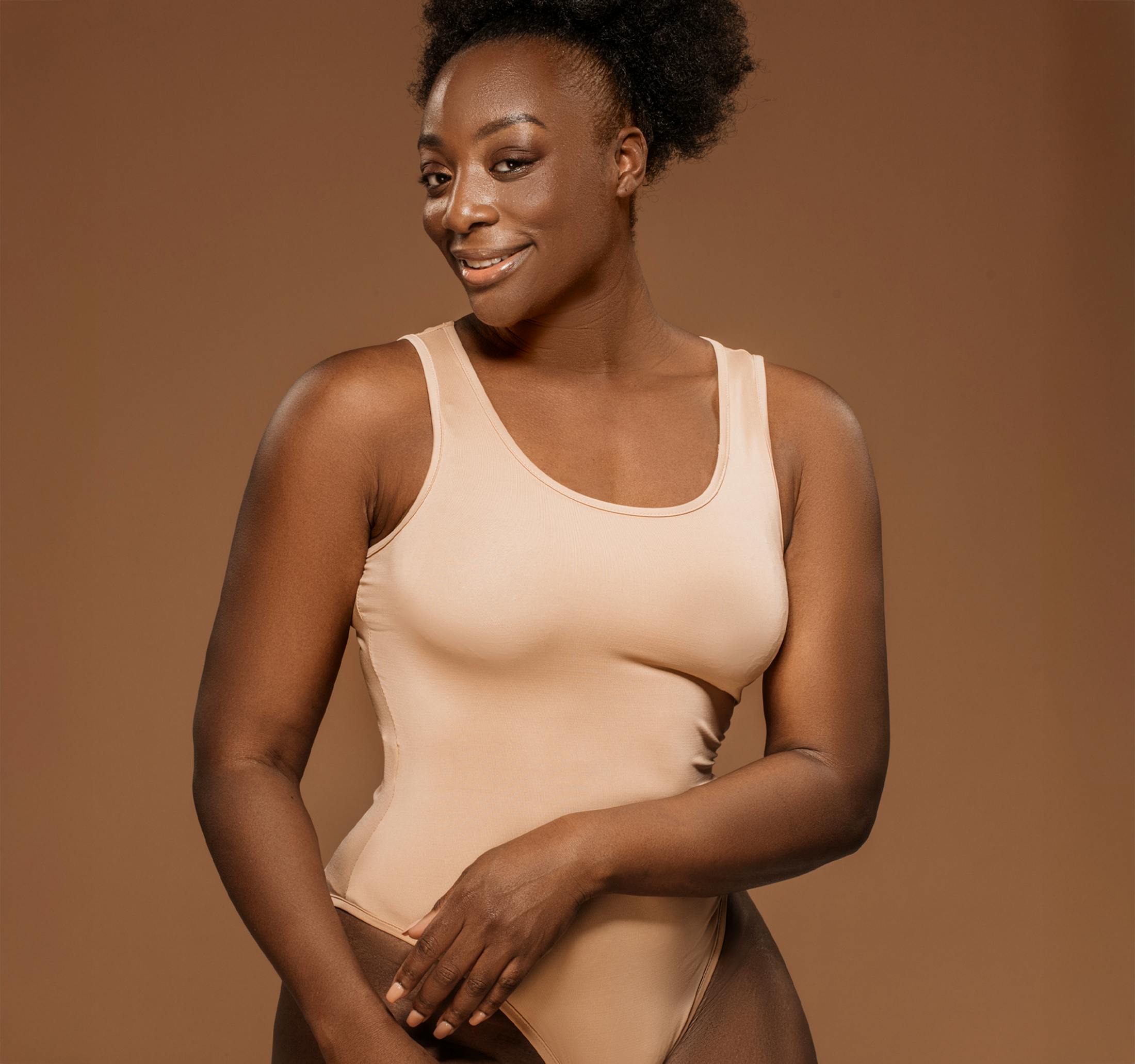 woman in beige bodysuit looking forward